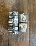 Black, grey and white swirl soaps topped with black sea salts.