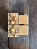 Image shows group of light orange soaps with  honeycomb top.