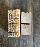 Tan soaps with gold glycerin soap honeybees on top.
