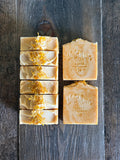 Yellow soaps with calendula petals on top.