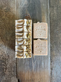 Tan speckled soaps with chamomile buds on top.