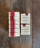 Bars of soap with a heart design on a wooden surface