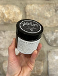 Image shows jar of charcoal face scrub