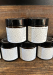 Stack of jars of charcoal face scrub