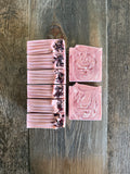 pink and red soaps with hibiscus petals on top